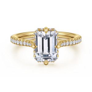 Gabriel & Co. ER16997E8Y44JJ 14 karat yellow gold Contemporary engagement ring, front view of an emerald cut center with a prong at the middle of each side
