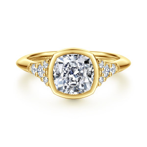 Gabriel & Co. ER16998C8Y44JJ 14 karat yellow gold Contemporary engagement ring, front view of a cushion cut center in a full bezel between small diamond clusters