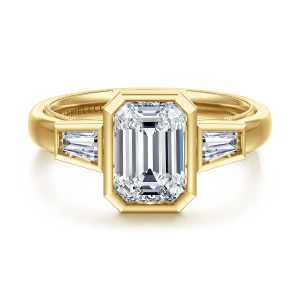 Gabriel & Co. ER17014E8Y43JJ 14 karat yellow gold Contemporary engagement ring, front view of an emerald cut center in a clipped corner bezel between tapered baguette diamonds