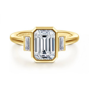 Gabriel & Co. ER17016E8Y43JJ 14 karat yellow gold Contemporary engagement ring, front view of an emerald cut center in a clipped corner bezel with a baguette on each side