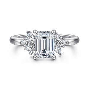 Gabriel & Co. ER17072E6W44JJ 14 karat white gold Starlight engagement ring, front view of an emerald cut center between small clusters of round and elongated diamonds