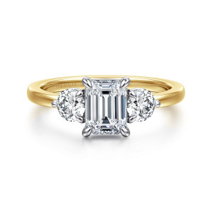 Gabriel & Co. ER17083E4M44JJ 14 karat white and yellow gold Contemporary engagement ring, front view of an emerald cut center flanked by two round diamonds on a plain band