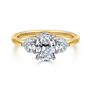 Gabriel & Co. ER17083O4M44JJ 14 karat white and yellow gold Contemporary engagement ring, front view of an oval center between two large round side stones on a slim smooth band