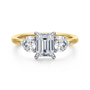 Gabriel & Co. ER17084E4M44JJ 14 karat white and yellow gold Contemporary engagement ring, front view of an emerald cut center flanked by large round side stones above a plain rounded band