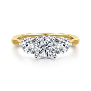 Gabriel & Co. ER17084R4M44JJ 14 karat white and yellow gold Contemporary engagement ring, front view of a round center between smaller side stones with tapered prongs and a slim band