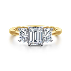 Gabriel & Co. ER17086E4M44JJ 14 karat white and yellow gold Contemporary engagement ring, front view of an upright emerald cut center between two elongated side stones with their own claws