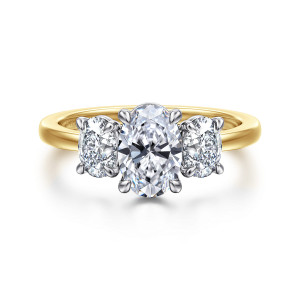 Gabriel & Co. ER17086O4M44JJ 14 karat white and yellow gold Contemporary engagement ring, front view of an oval center and matching side stones in claw prongs above a smooth band
