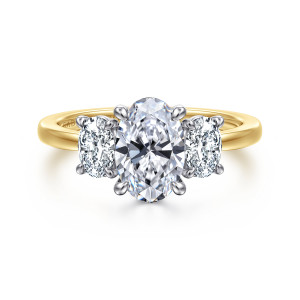 Gabriel & Co. ER17086O6M44JJ 14 karat white and yellow gold Contemporary engagement ring, front view of a tall oval center between two oval diamonds, each stone with its own small prongs