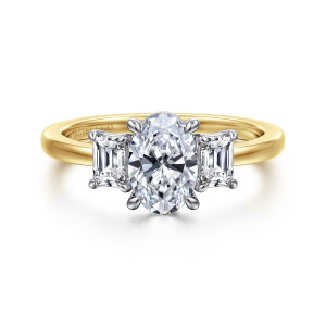 Gabriel & Co. ER17087O4M43JJ 14 karat white and yellow gold Contemporary engagement ring, front view of an oval center flanked by two emerald cut side stones on a plain band