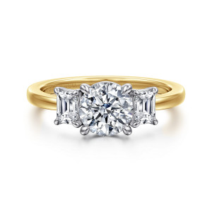 Gabriel & Co. ER17087R4M43JJ 14 karat white and yellow gold Contemporary engagement ring, front view of a round center between step cut side stones on a smooth band, maker's mark inside