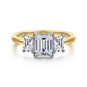 Gabriel & Co. ER17088E4M43JJ 14 karat white and yellow gold Contemporary engagement ring, front view of an emerald cut center flanked by step cut side stones over a slim smooth band