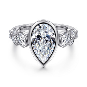 Gabriel & Co. ER17095P10W44JJ 14 karat white gold Contemporary engagement ring, front view of a pear shaped center in a smooth bezel with mixed shape stones on each shoulder
