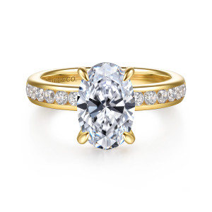 Gabriel & Co. ER17101O8Y44JJ 14 karat yellow gold Classic engagement ring, front view of the oval center above channel set round diamonds on either side