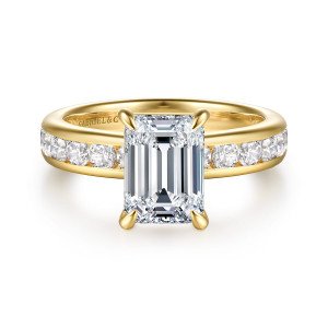 Gabriel & Co. ER17102E8Y44JJ 14 karat yellow gold Classic engagement ring, front view of an emerald cut center with claw prongs between channel set round diamonds