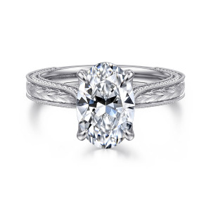 Gabriel & Co. ER17104O8W44JJ 14 karat white gold Victorian engagement ring, front view of an oval center on four prongs above a band engraved with leaves between beaded edges