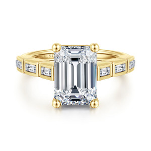 Gabriel & Co. ER17108E13Y43JJ 14 karat yellow gold Contemporary engagement ring, front view of an emerald cut center with ball tipped prongs above bezel set baguette shoulders