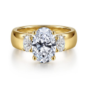 Gabriel & Co. ER17366O8Y44JJ 14 karat yellow gold Contemporary engagement ring, front view of an oval center between oval side stones on a wide polished band