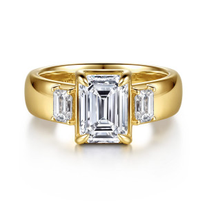 Gabriel & Co. ER17367E8Y43JJ 14 karat yellow gold Contemporary engagement ring, front view of an emerald cut center in a square basket between two emerald cut side diamonds
