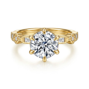 Gabriel & Co. ER17373R8Y44JJ 14 karat yellow gold Victorian engagement ring, front view of the round center in six teardrop tipped prongs with baguettes beside the head