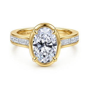 Gabriel & Co. ER17387O8Y43JJ 14 karat yellow gold Contemporary engagement ring, front view of an oval center inside a smooth oval collar with baguette diamonds on each shoulder