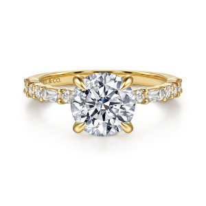 Gabriel & Co. ER17391R8Y44JJ 14 karat yellow gold Contemporary engagement ring, front view of a round center with baguette and round diamonds spaced along both shoulders