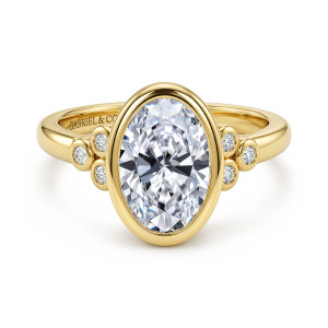 Gabriel & Co. ER17392O8Y44JJ 14 karat yellow gold Contemporary engagement ring, front view of a bezel wrapped oval center with a triangular diamond cluster on each side