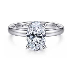 Gabriel & Co. ER17435O8W44JJ 14 karat white gold Contemporary engagement ring, front view of an oval center held by four prongs on a plain polished band