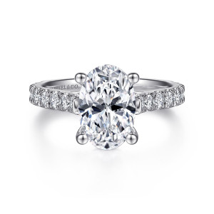 Gabriel & Co. ER7016O8W44JJ 14 karat white gold Classic engagement ring, front view of an oval center in four ball tipped prongs with round stones on each shoulder