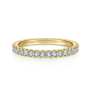 Gabriel & Co. LR50889Y4JAQ 14 karat yellow gold Stackable ring, front view of a band with a row of light blue stones and a maker's mark inside