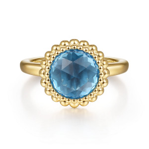 Gabriel & Co. LR51792Y4JBT 14 karat yellow gold Bujukan ring, front view of a faceted round blue stone with a scalloped rim of metal beads