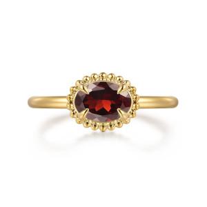 Gabriel & Co. LR52558Y4JGN 14 karat yellow gold Bujukan ring, front view of an oval red stone lying sideways in a rim of metal beads