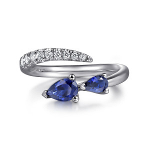 Gabriel & Co. LR52707W45SA 14 karat white gold Color ring, front view of the bypass ends, a diamond row beside two blue pear shaped stones