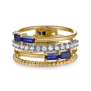 Gabriel & Co. LR52769M45SA 14 karat white and yellow gold Bujukan ring, front view of blue baguette stones, a diamond row and a polished bead strand