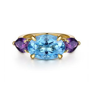 Gabriel & Co. LR52824Y4JMC 14 karat yellow gold Color ring, front view of the light blue oval set sideways between two violet pear shaped stones