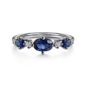 Gabriel & Co. LR52833W45SA 14 karat white gold Color ring, front view of the sideways blue oval, smaller blue ovals and round diamonds between them