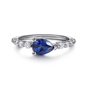 Gabriel & Co. LR52834W45SA 14 karat white gold Color ring, front view of a sideways blue pear stone with round diamonds spaced between beads
