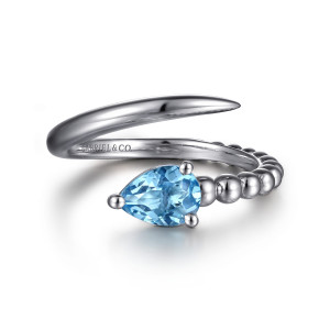 Gabriel & Co. LR52863SVJBT sterling silver Bujukan ring, front view of the pear shaped blue stone in prongs beside the smooth tapered arm