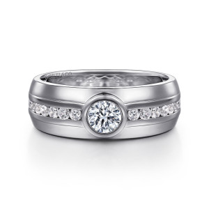 Gabriel & Co. MR20049W44JJ 14 karat white gold Monument men's ring, front view of the larger bezel diamond splitting the small channel diamonds across a broad band