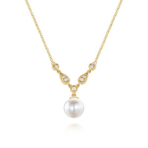 Gabriel & Co. NK1420Y45PL 14 karat yellow gold Color necklace, front view of the pearl drop under the V of teardrop frames and round bezel set diamonds
