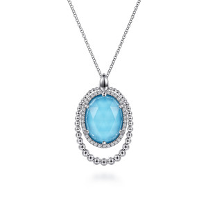 Gabriel & Co. NK6543XTSVJMC sterling silver Bujukan necklace, front view of the blue oval stone, its halo, the bead rings and the drop shaped bail