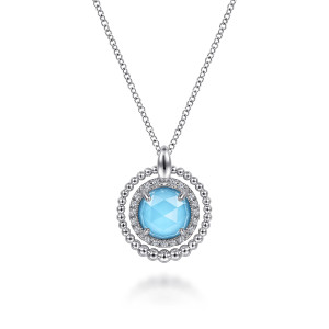 Gabriel & Co. NK6544XTSVJMC sterling silver Bujukan necklace, front view of the blue faceted stone with its pave halo and outer bead ring