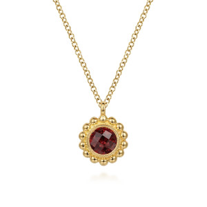 Gabriel & Co. NK7057Y4JGN 14 karat yellow gold Bujukan necklace, front view of the red faceted stone, its milgrain bezel and the scalloped bead border