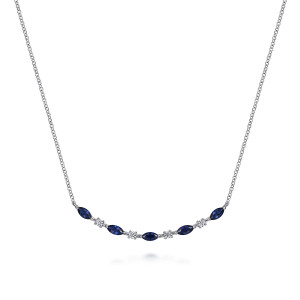 Gabriel & Co. NK7253W45SA 14 karat white gold Color necklace, front view of the curved bar with blue marquise stones held at their tips by prongs