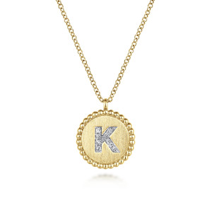 Gabriel & Co. NK7418K-Y45JJ 14 karat yellow gold Bujukan necklace, front view of the brushed disc, bead rim, loop bail and diamond set letter K