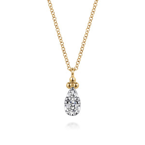 Gabriel & Co. NK7747Y45JJ 14 karat yellow gold Bujukan necklace, front view of the pear shaped diamond drop under its crown of polished metal beads