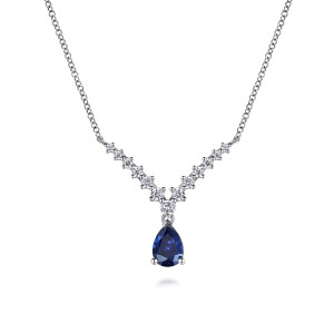 Gabriel & Co. NK7864W45SA 14 karat white gold Color necklace, front view of the V of prong set stones with the blue pear stone below