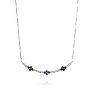 Gabriel & Co. NK8131W45SA 14 karat white gold Color necklace, front view of blue blossom clusters spaced along the slender stone lined bar