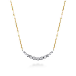 Gabriel & Co. NK8285M45JJ 14 karat white and yellow gold Lusso necklace, front view of a crescent bar of graduated round stones on a chain