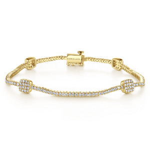 Gabriel & Co. TB3897Y45JJ 14 karat yellow gold Lusso bracelet, front view of a tennis line with cushion shaped pave stations and a box clasp