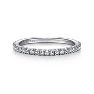 Gabriel & Co. WB14914O2W44JJ 14 karat white gold Contemporary wedding band, front view of small round diamonds in prongs with the stone row continuing around the sides